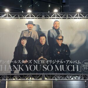 サザンオールスターズのアルバム広告。照明に照らされたメンバーのポートレートとリリース日。