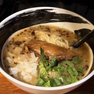 横浜浜虎の塩ラーメン。湯気が立ち上るラーメン鉢には、チャーシュー、ネギ、玉ねぎなど。